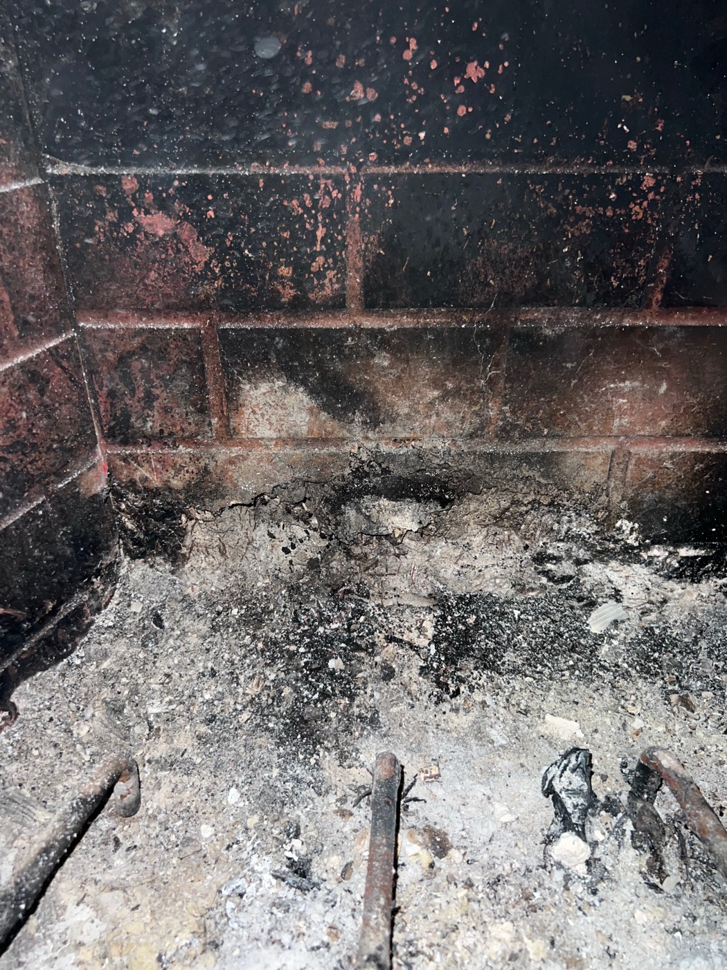 Firebox before repair: cracked mortar joints and heavy ash in a Dallas-Fort Worth fireplace