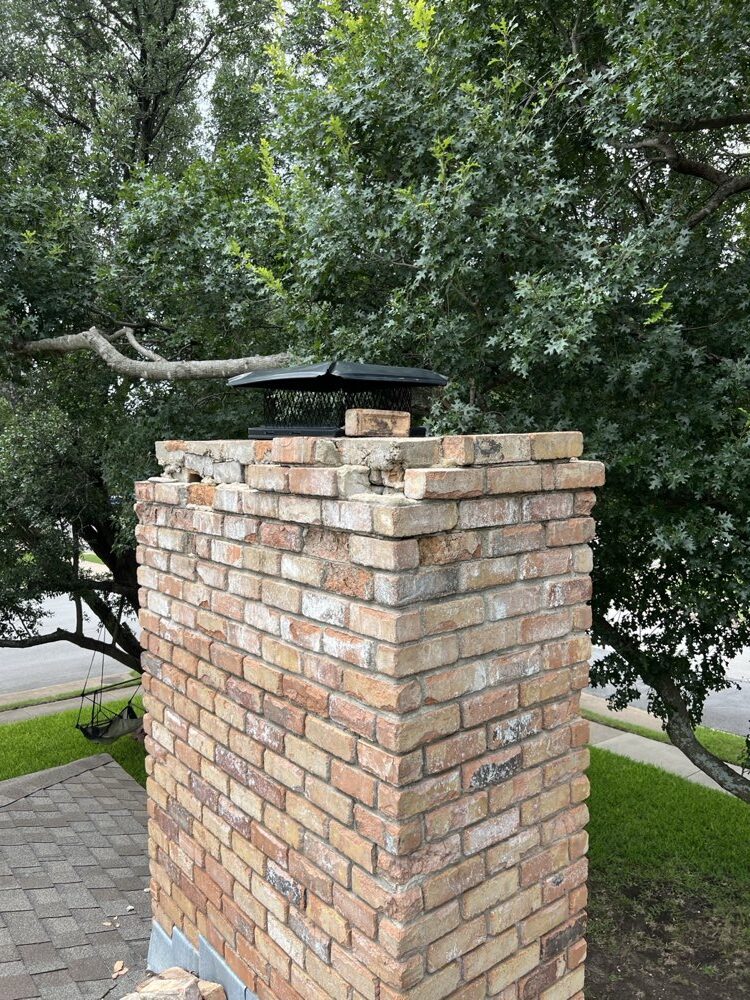 Cracked chimney crown before repair on a Dallas home