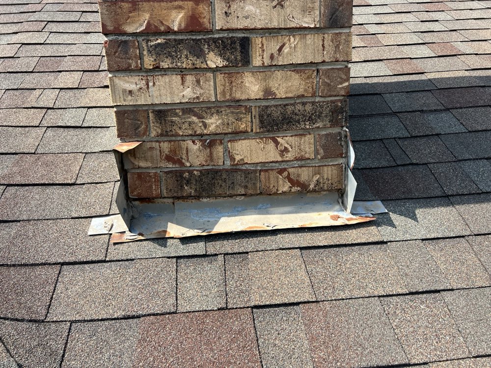 Chimney flashing at the roofline during repair