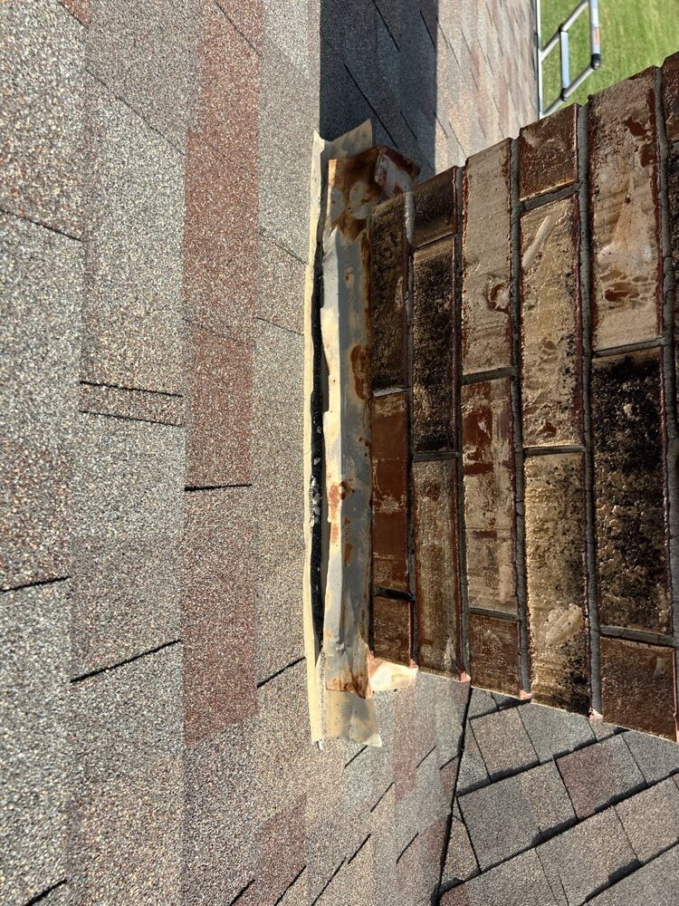 New step flashing installed where chimney meets roof