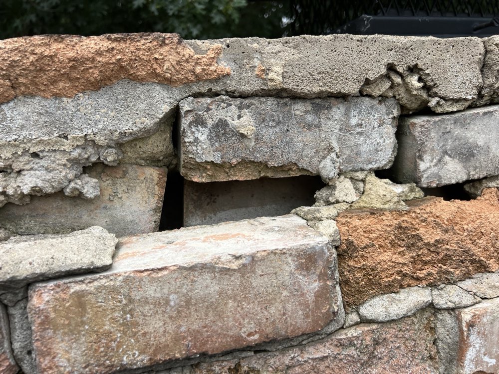 Masonry chimney rebuild in progress on a DFW roof