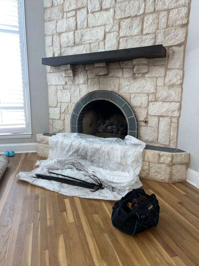 Flue brush and vacuum setup during a chimney sweep